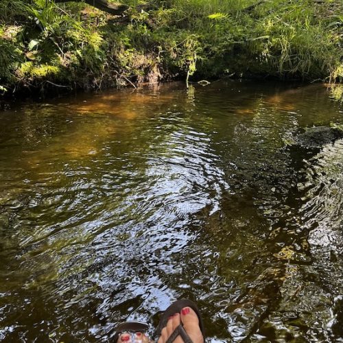 relaxing by stream